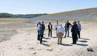 Government officials on the dry floor of Lake Mendocino