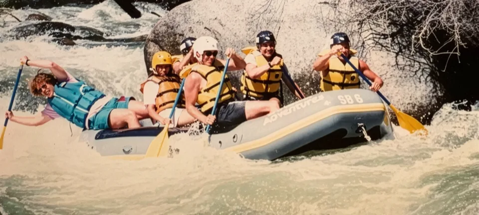Photo of Jon Bishop and five friends whitewater water rafting in gray and yellow raft. Credit: Jon Bishop