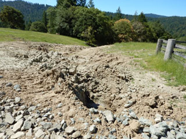 Unpermitted grading within a stream, resulting in an altered stream bed and erosion