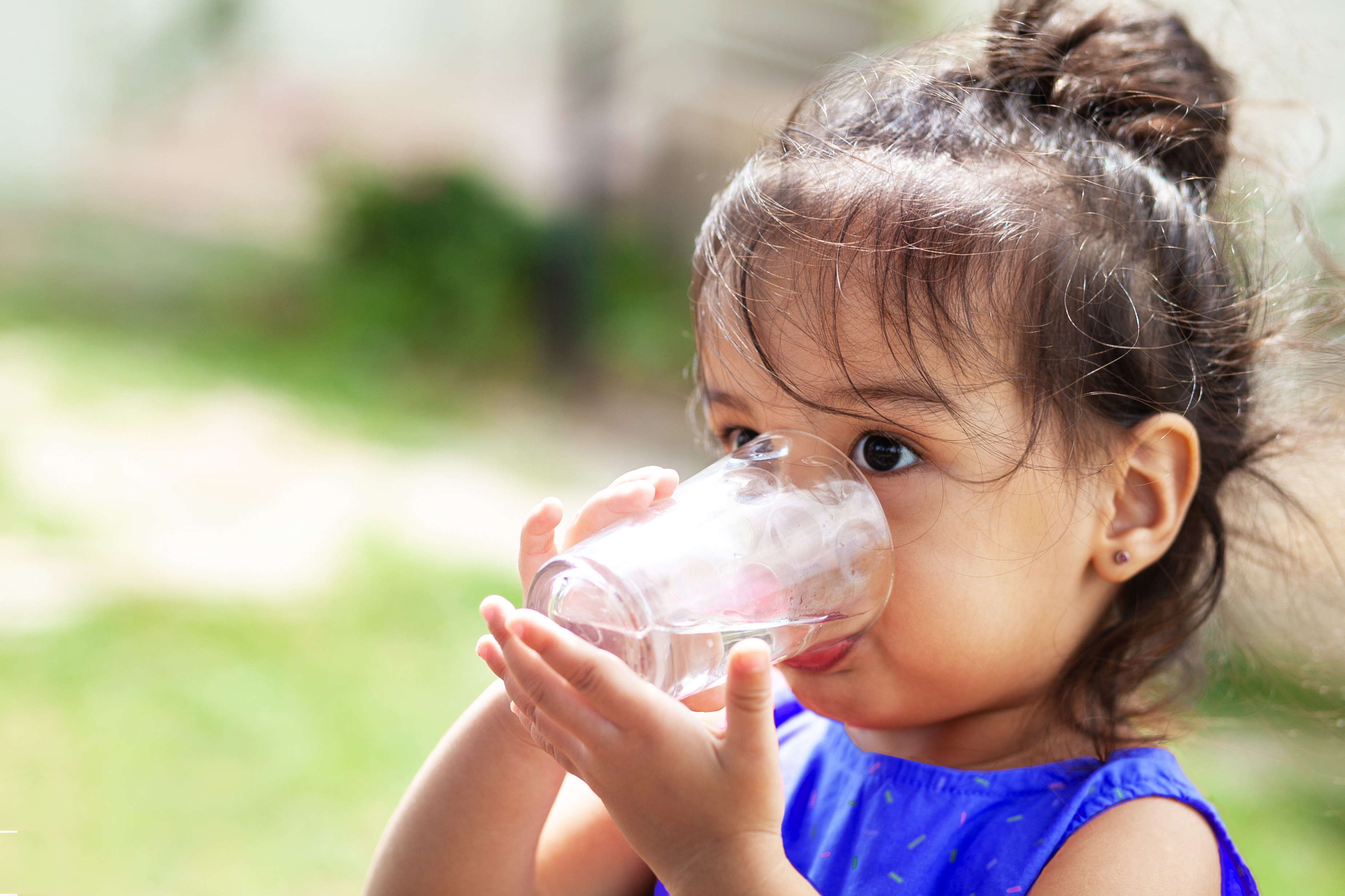 A child drinking a glass of water
